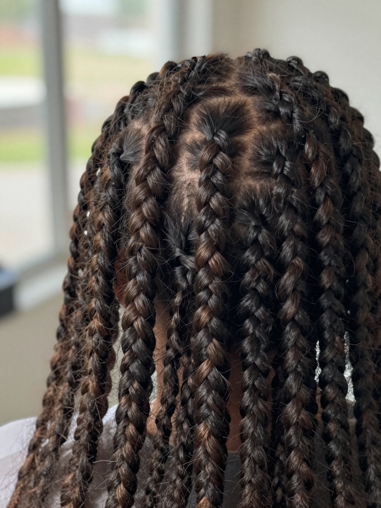 Close-up of a knotless braid feed-in root showing no bump or knot